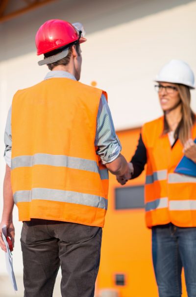 Business handshake on construction site