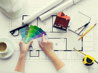 close up of hands with color palette and blueprint